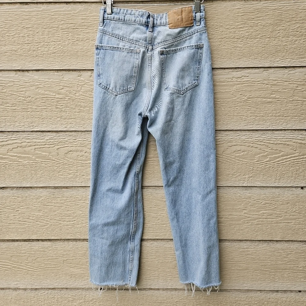 Zara light wash straight leg jeans with busted knee and raw hem size 2